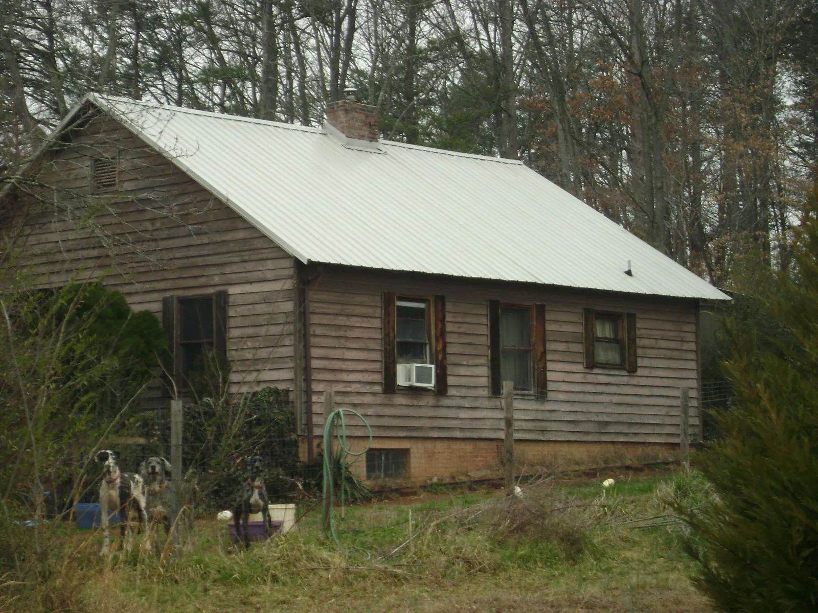 White metal roof on an old wood sided farmhouse, from a Metal Roof Installation job in Fordyce